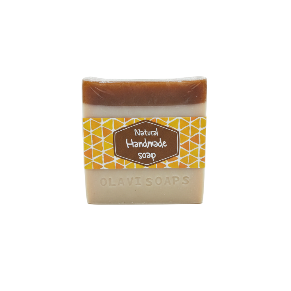 Bar of natural handmade soap with a decorative label on a white background